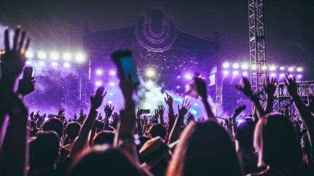 group of people raising there hands in concert